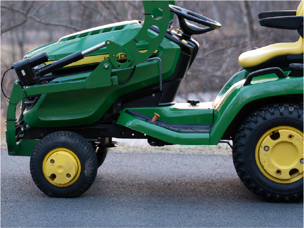 LGM-100 scooping mulch with a John Deere X500 lawn tractor