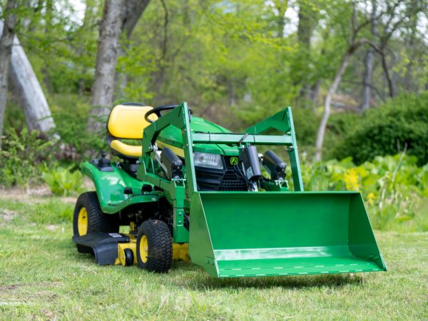 The LGM QORE Utility Attachment mounted to a John Deere X350 parked on grass.