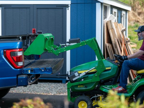 LGM QORE lifting a log splitter into the bed of a pickup truck