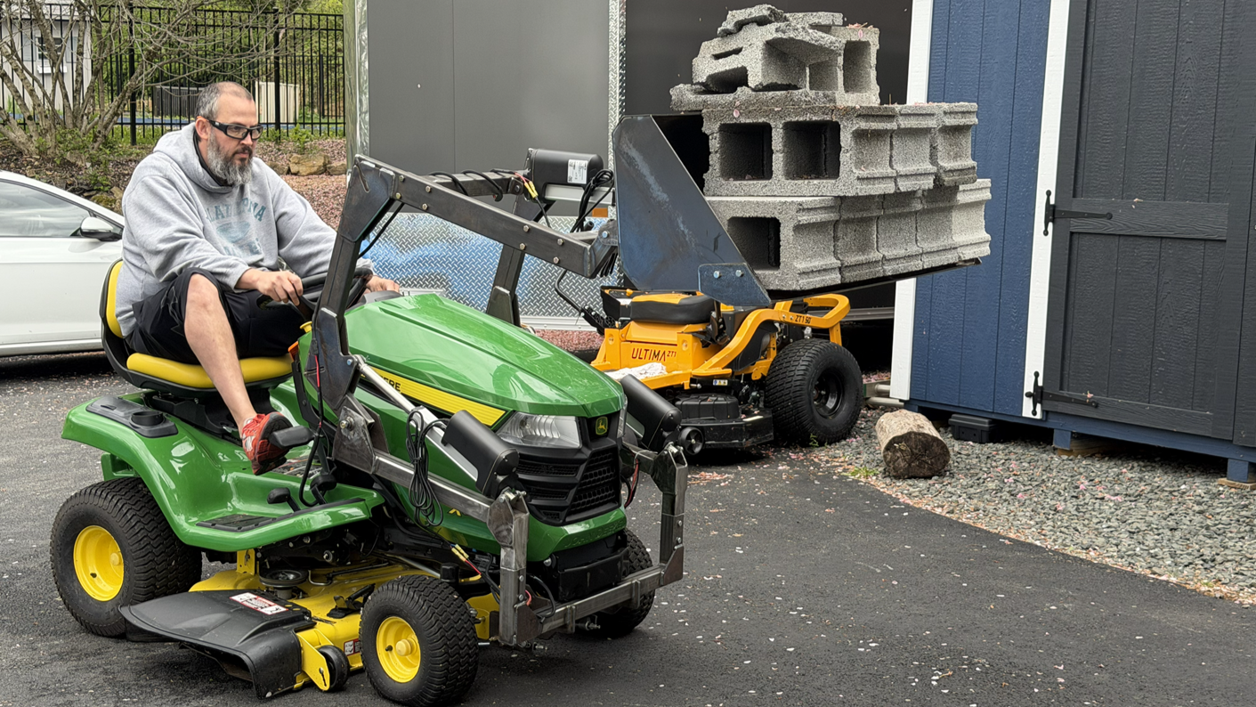 QORE Smart Utility Attachment durability testing with heavy-load cinder block performance evaluation